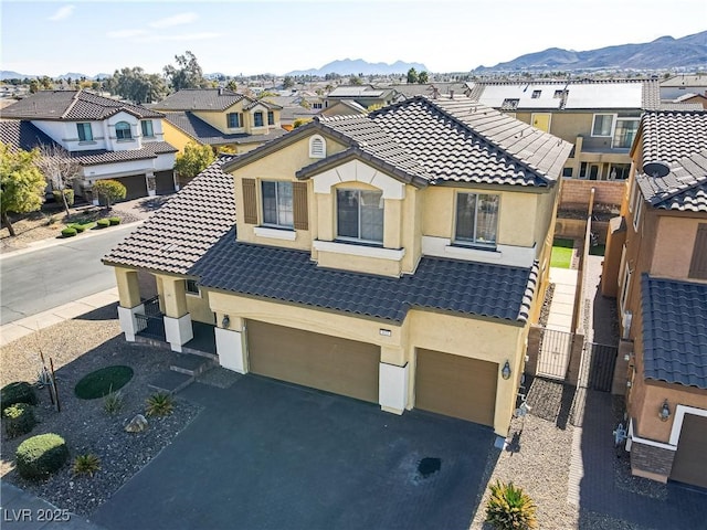 view of front facade featuring a garage and a mountain view