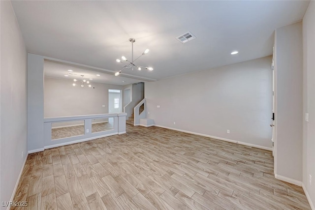 interior space with a notable chandelier and light wood-type flooring