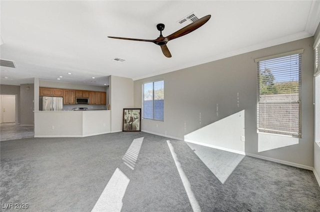 unfurnished living room with light carpet and ceiling fan