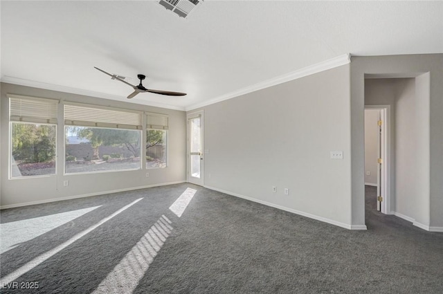 spare room featuring dark colored carpet, ornamental molding, and ceiling fan