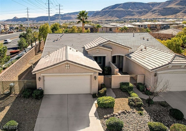 ranch-style home with a garage and a mountain view