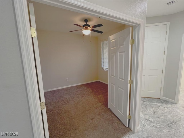 unfurnished room with light carpet and ceiling fan