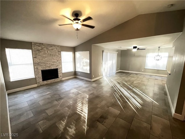 unfurnished living room featuring ceiling fan, lofted ceiling, and a stone fireplace