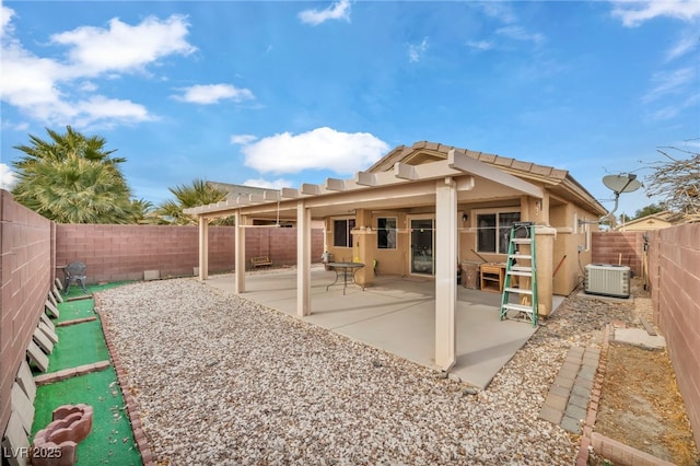 back of house with central AC, a patio, a fenced backyard, and stucco siding