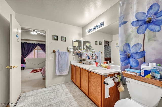 bathroom with vanity, toilet, and a textured ceiling