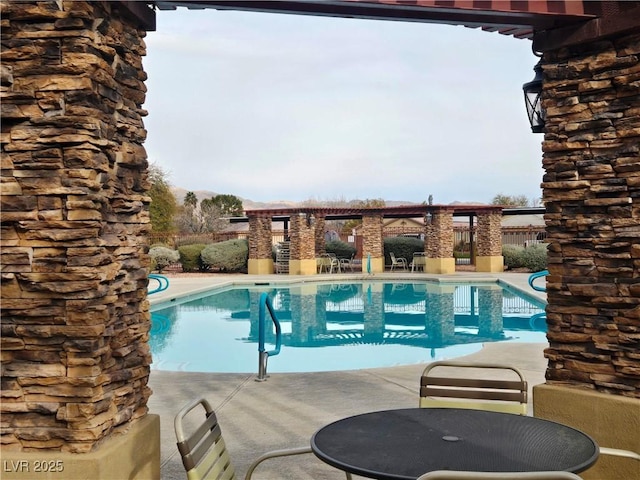 view of swimming pool with a patio