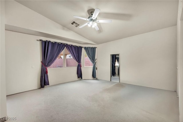 empty room with a ceiling fan, visible vents, vaulted ceiling, and carpet flooring