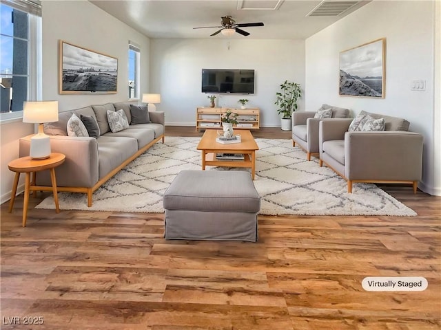 living room with hardwood / wood-style floors and ceiling fan