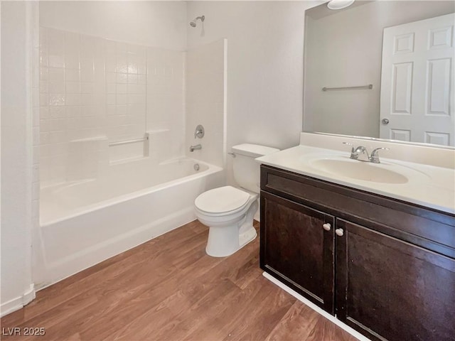 bathroom featuring shower / tub combination, vanity, toilet, and wood finished floors