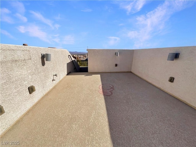 view of patio featuring a balcony