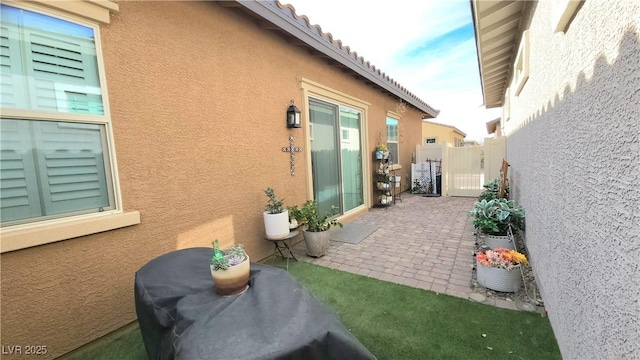 view of home's exterior featuring a patio area, stucco siding, and fence