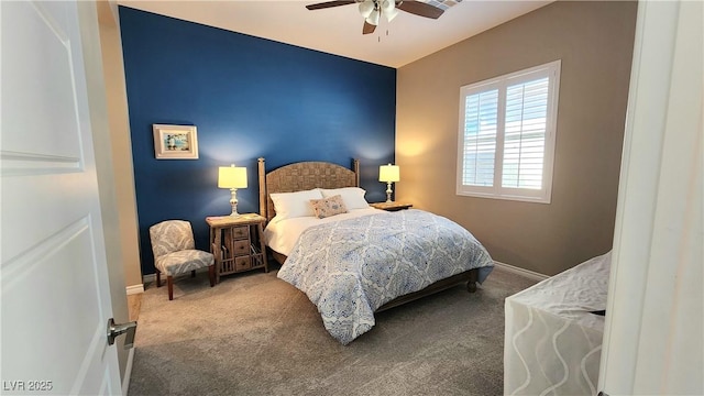 carpeted bedroom with ceiling fan and baseboards