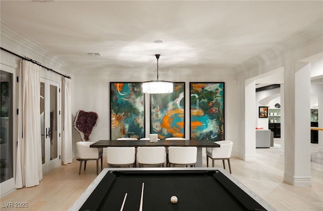 dining room with crown molding, pool table, french doors, a chandelier, and light wood-type flooring