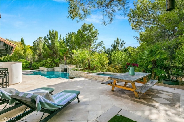 view of pool featuring a patio area and an in ground hot tub