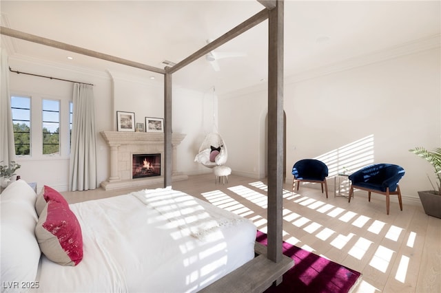 bedroom featuring ornamental molding and light hardwood / wood-style flooring