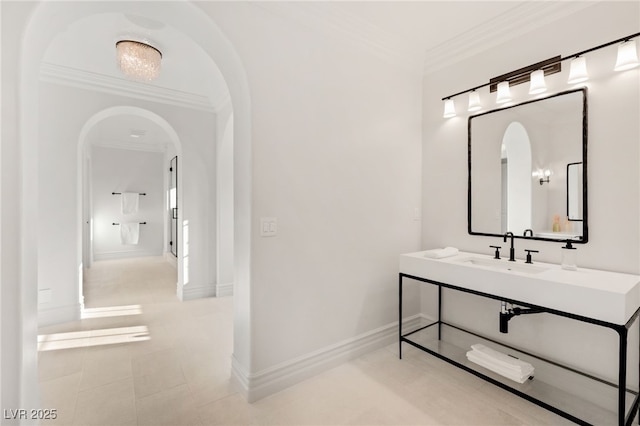 bathroom with crown molding and sink