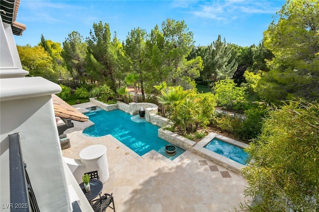 view of swimming pool with an in ground hot tub and a patio