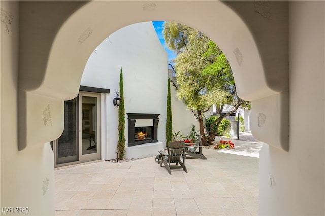 view of patio with an outdoor fireplace