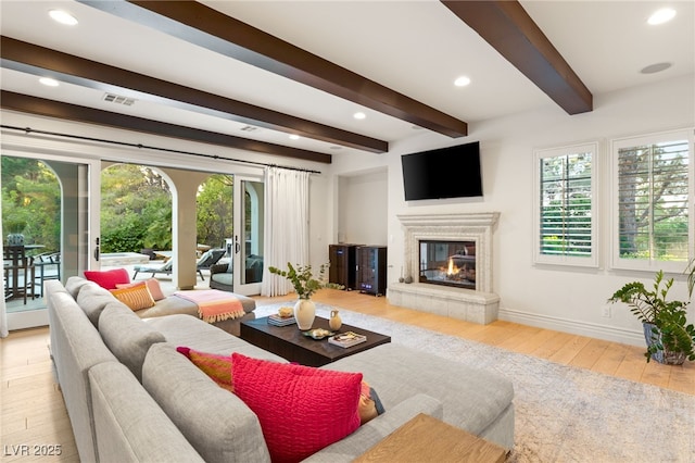 living room with beam ceiling and light hardwood / wood-style floors