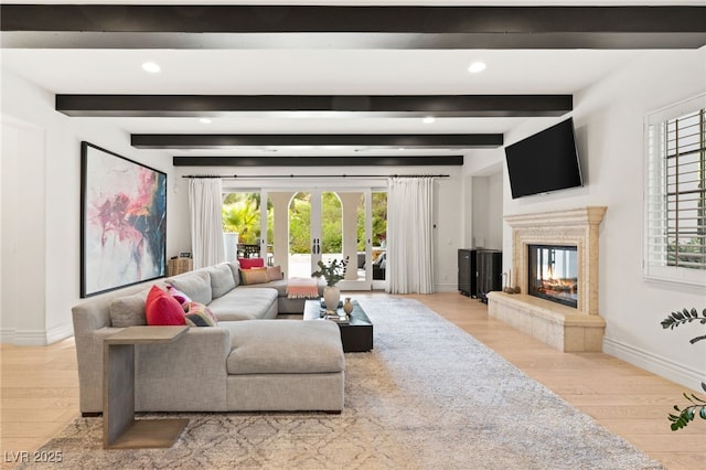 living room featuring light hardwood / wood-style floors, french doors, and beamed ceiling