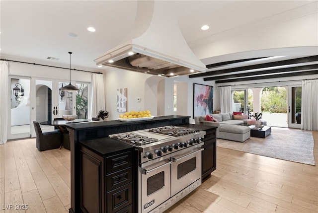 kitchen with hanging light fixtures, double oven range, island exhaust hood, and light hardwood / wood-style floors