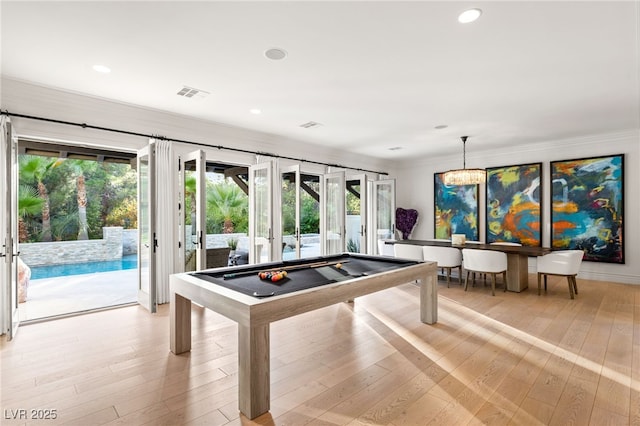 recreation room with crown molding, plenty of natural light, pool table, and french doors