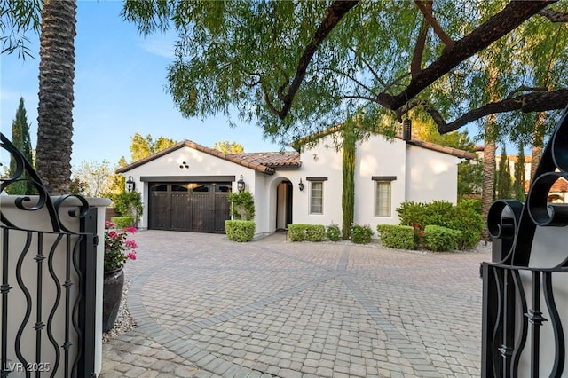 mediterranean / spanish-style home with a garage