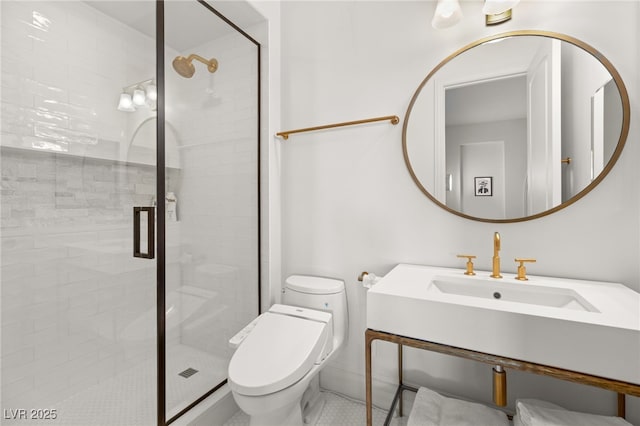 bathroom featuring sink, a shower with shower door, and toilet