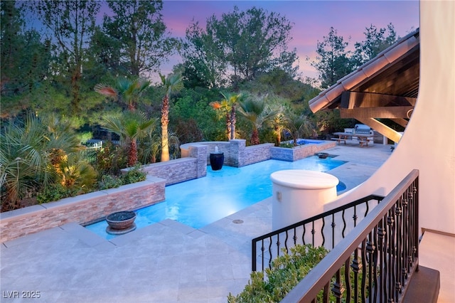 pool at dusk featuring a gazebo, a hot tub, and a patio area