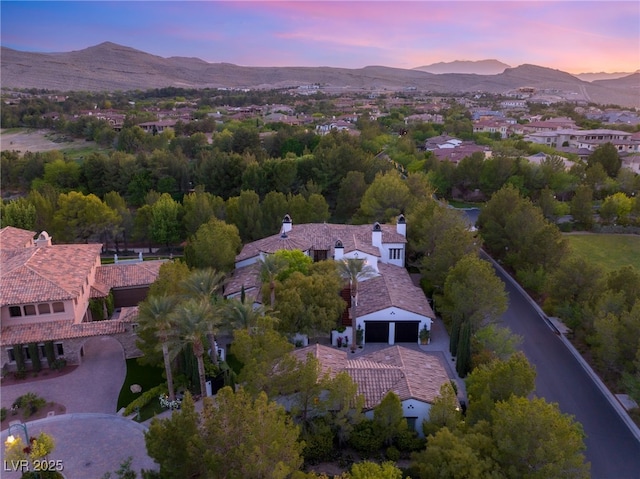 aerial view at dusk featuring a mountain view