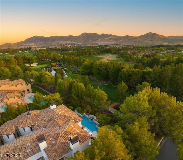 aerial view at dusk featuring a mountain view