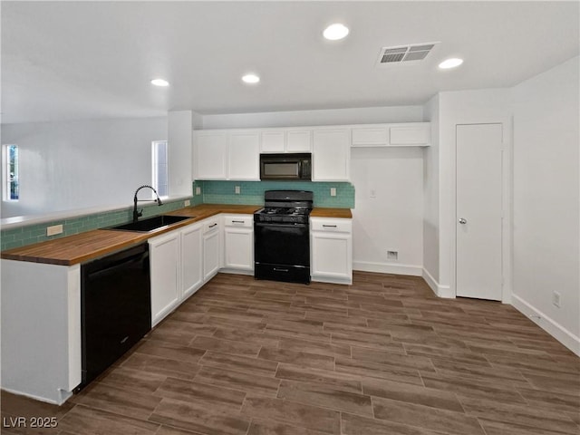 kitchen featuring white cabinetry, sink, wooden counters, dark hardwood / wood-style flooring, and black appliances