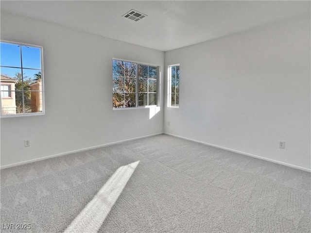 carpeted empty room with plenty of natural light