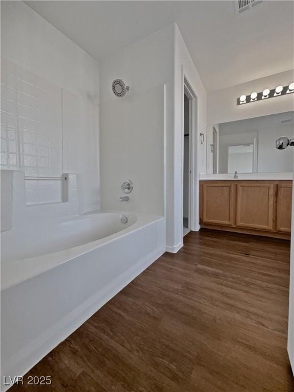 bathroom with vanity, wood-type flooring, and shower / bathing tub combination