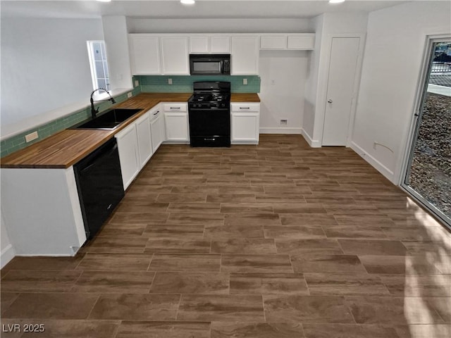 kitchen with white cabinetry, sink, wood counters, and black appliances