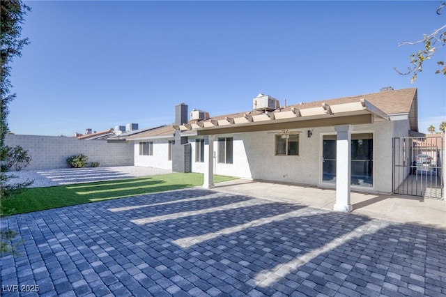 rear view of property featuring cooling unit and a patio area