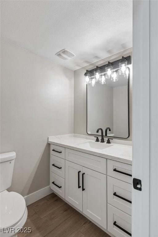 bathroom featuring hardwood / wood-style flooring, vanity, and toilet