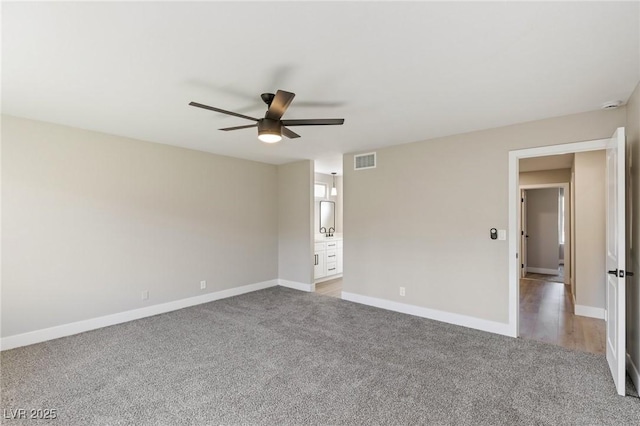 carpeted spare room with ceiling fan