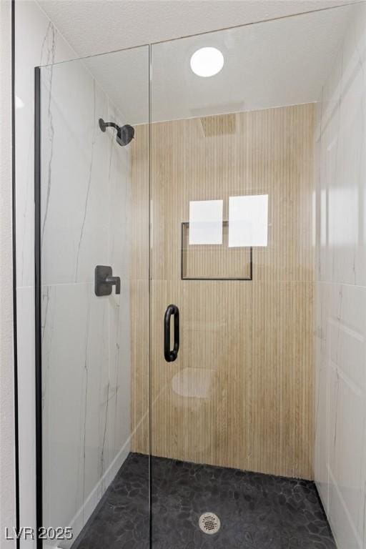 bathroom featuring a shower with door