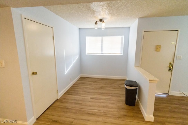 interior space featuring a textured ceiling and light hardwood / wood-style floors