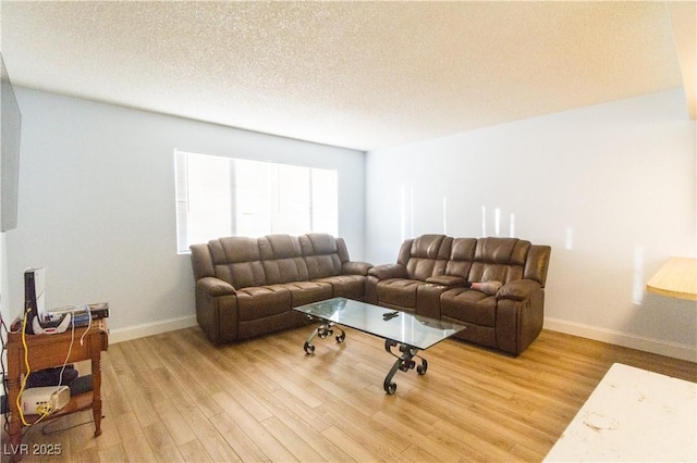 living room with hardwood / wood-style floors and a textured ceiling