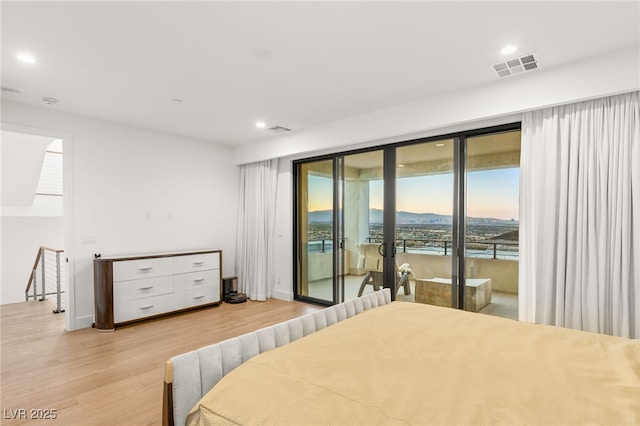 bedroom featuring access to exterior and light hardwood / wood-style flooring