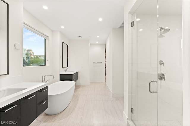 bathroom featuring vanity and shower with separate bathtub