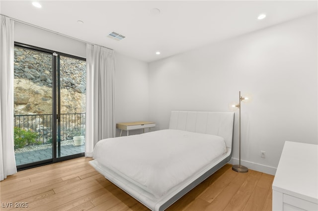 bedroom featuring access to outside and light hardwood / wood-style flooring