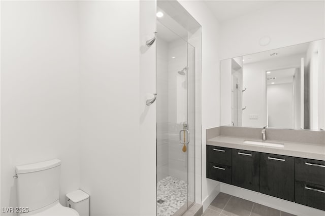 bathroom featuring vanity, a shower with shower door, tile patterned floors, and toilet