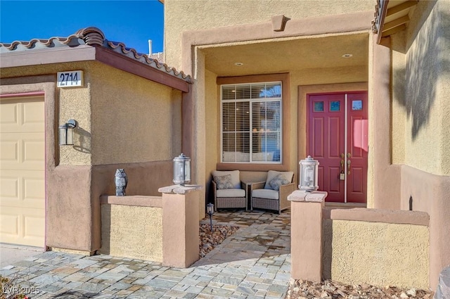 doorway to property with a garage