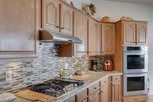 kitchen featuring backsplash, light brown cabinets, and appliances with stainless steel finishes