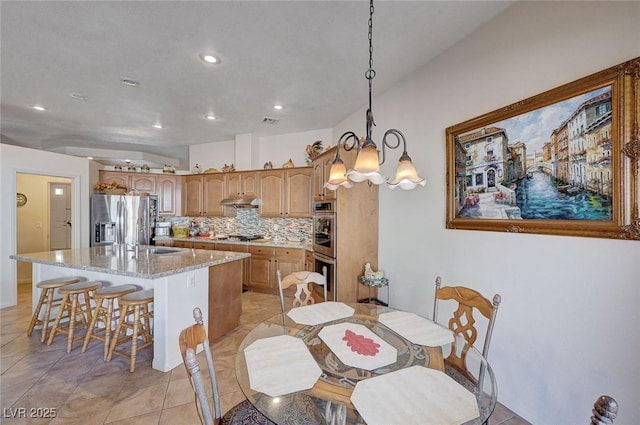 tiled dining space with a notable chandelier