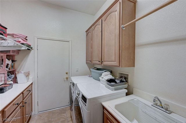 laundry area with washer and dryer, sink, and cabinets