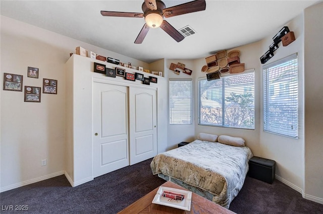 carpeted bedroom featuring ceiling fan and a closet